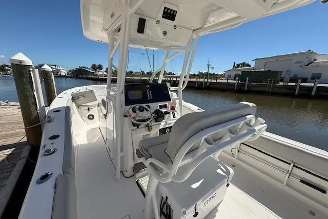 Slide: The Image of 2023 Sea Fox 268 Commander boat interior at a dock, featuring helm and seating. - 25