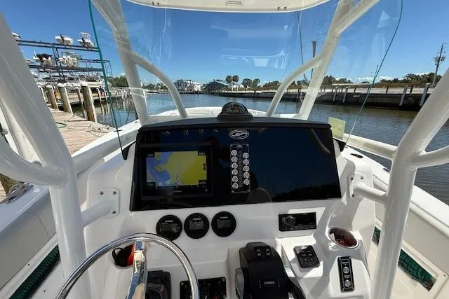 Slide: The Image of 2023 Sea Fox 268 Commander boat dashboard with navigation system, docked by the water. - 27