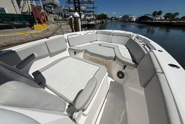 Slide: The Image of 2023 Sea Fox 268 Commander boat with spacious seating and sleek design at a marina. - 31