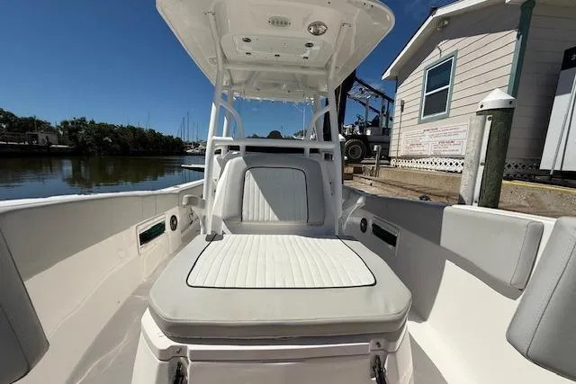 Slide: The Image of 2023 Sea Fox 268 Commander boat interior with cushioned seating, dockside view. - 34