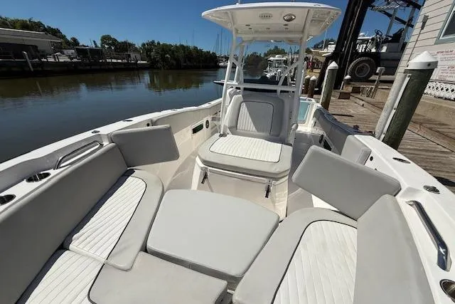 Slide: The Image of 2023 Sea Fox 268 Commander boat with spacious seating, docked by a calm river. - 36