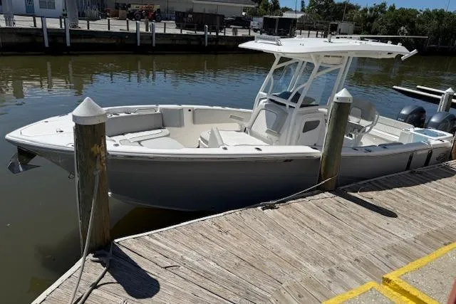 Slide: The Image of 2023 Sea Fox 268 Commander boat docked at a marina, featuring a sleek design and spacious deck. - 5
