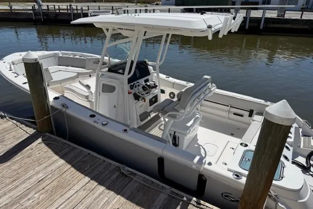 Slide: The Image of 2023 Sea Fox 268 Commander boat docked, featuring a sleek design and modern console. - 6