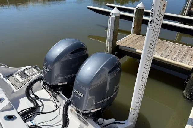 Slide: The Image of 2023 Sea Fox 268 Commander with twin 150 horsepower engines docked by the water. - 8