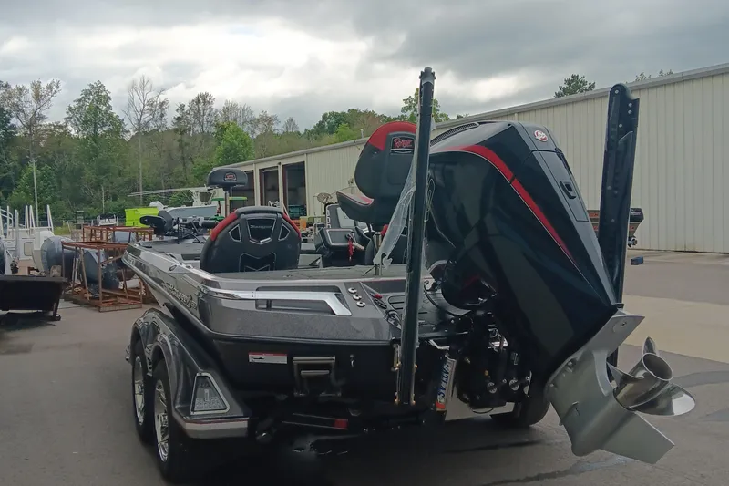 Slide: The Image of 2026 Ranger Z520 boat with powerful outboard motor, parked outdoors near a warehouse. - 6