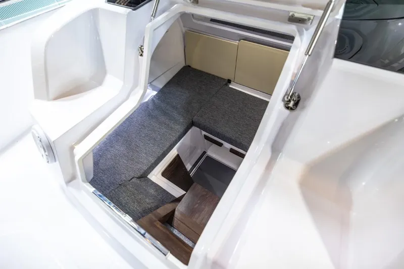 Slide: The Image of 2025 Axopar 29 Sun Top cabin interior with seating and storage. - 8