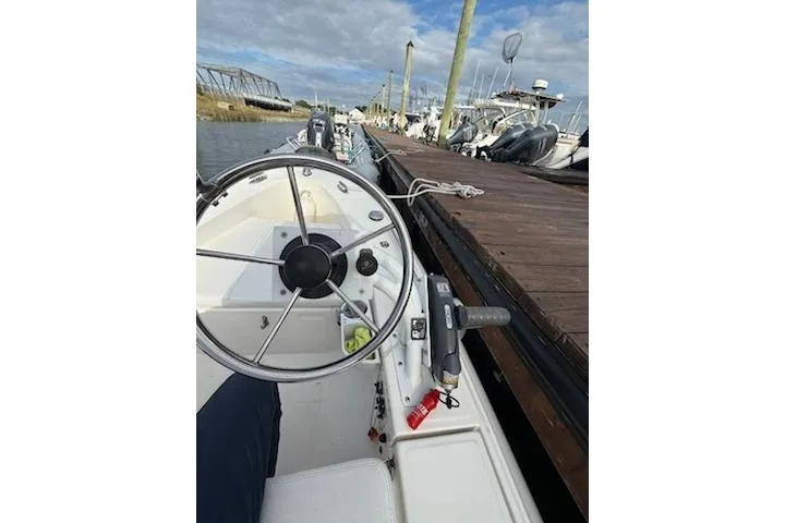 Slide: The Image of 2011 Rigid Boats 10.4 Sport steering wheel and controls at dockside. - 4