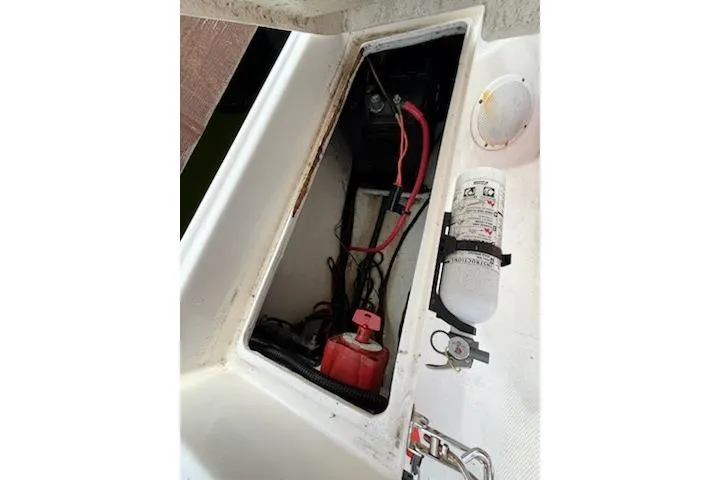 Slide: The Image of Open compartment of 2011 Rigid Boats 10.4 Sport showing wiring and fire extinguisher. - 5