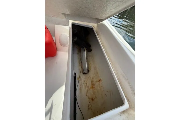 Slide: The Image of Open storage compartment in a 2011 Rigid Boats 10.4 Sport, showing interior details. - 6