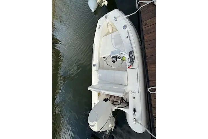 Slide: The Image of 2011 Rigid Boats 10.4 Sport, white, docked, aerial view, calm water. - 7