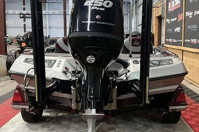 Slide: The Image of 2018 Ranger Z520L boat with 250 Pro outboard motor in a garage setting. - 2