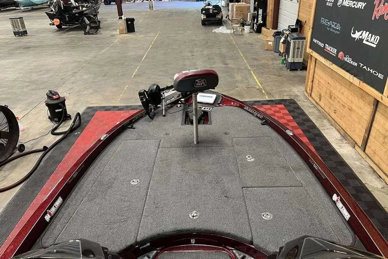 Slide: The Image of 2018 Ranger Z520L boat interior in a garage, featuring a spacious deck and equipment. - 7
