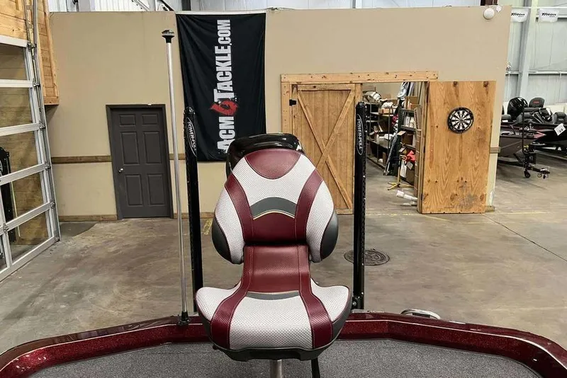 Slide: The Image of 2018 Ranger Z520L boat seat in a garage with a dartboard and banner. - 9