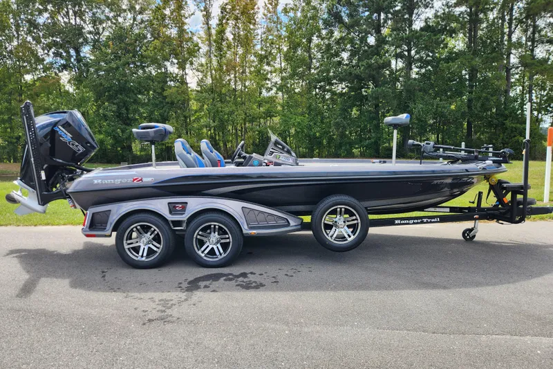 The Image of 2022 Ranger Z520R Cup Equipped boat on trailer, parked on road with forest background. - 0