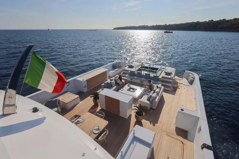 Slide: The Image of Luxurious 2023 Canados Expedition Yacht with spacious deck, Italian flag, and ocean view. - 34