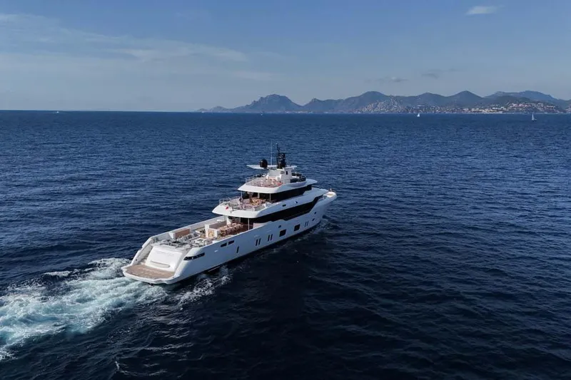 Slide: The Image of 2023 Canados Expedition Yacht cruising on open sea with scenic mountain backdrop. - 52