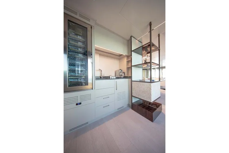 Slide: The Image of Modern kitchen interior on 2023 Canados Expedition Yacht, featuring sleek cabinetry and wine cooler. - 7