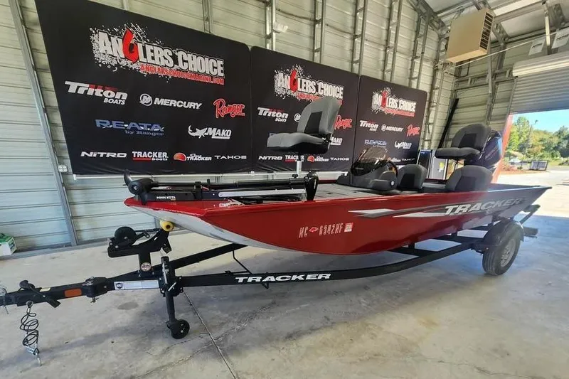 Slide: The Image of 2025 Tracker Pro 170 boat in showroom, red color, displayed on trailer. - 5