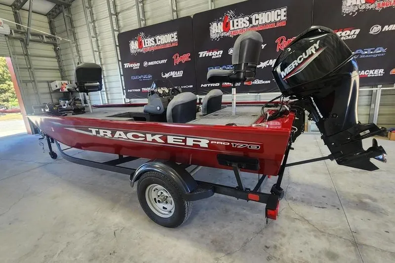Slide: The Image of 2025 Tracker Pro 170 boat in a showroom, featuring a Mercury outboard motor. - 8
