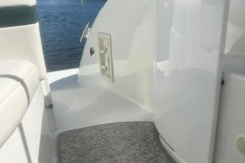 Slide: The Image of 2003 Formula 370 Super Sport boat interior with white seating and water view. - 10