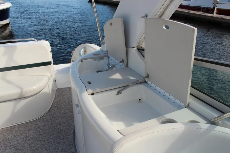 Slide: The Image of 2003 Formula 370 Super Sport boat interior with open storage compartments by the water. - 11