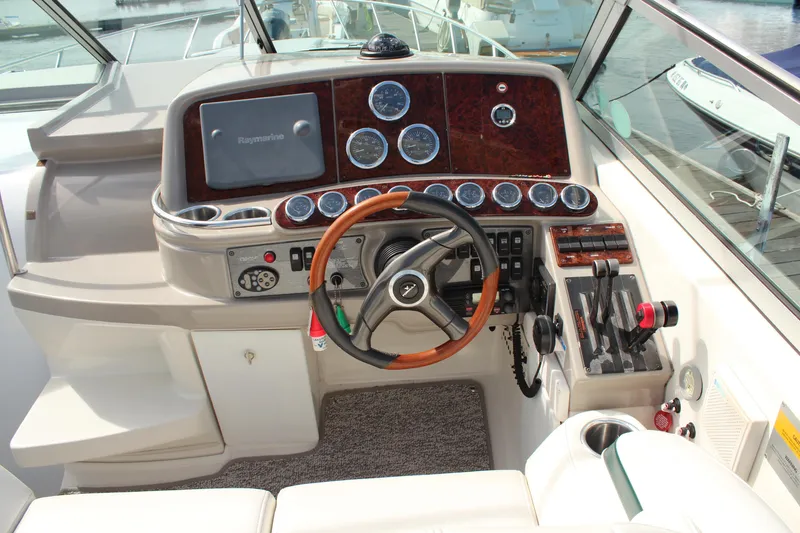 Slide: The Image of 2003 Formula 370 Super Sport boat dashboard with steering wheel and control panel. - 13