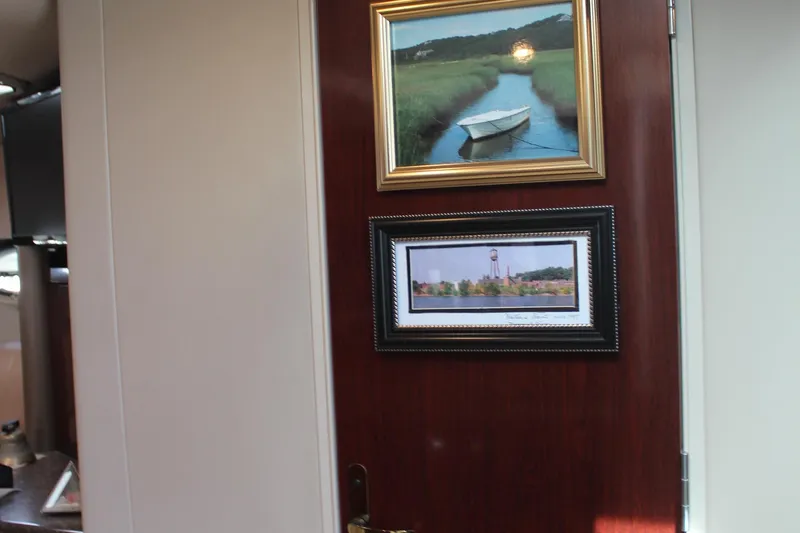 Slide: The Image of Framed artwork on a wooden door inside a 2003 Formula 370 Super Sport boat. - 20