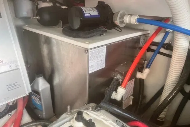 Slide: The Image of Engine compartment of 2003 Formula 370 Super Sport with various hoses and components. - 24