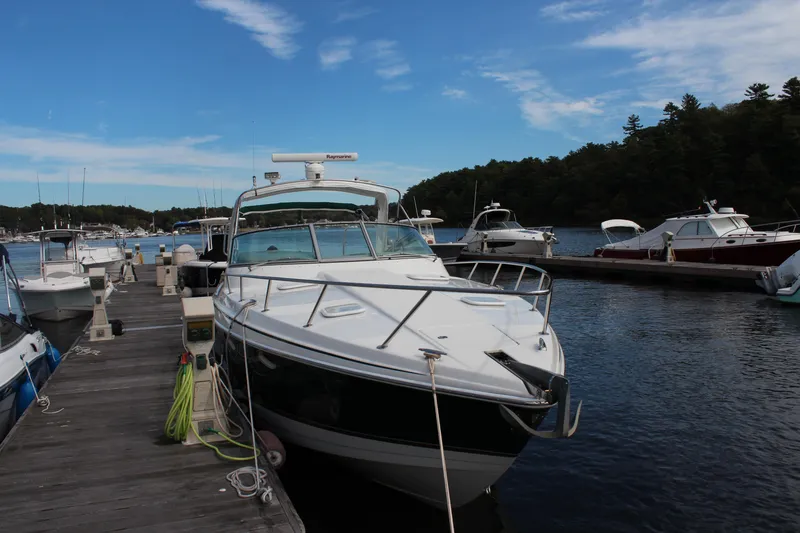 Slide: The Image of 2003 Formula 370 Super Sport boat docked at marina under blue sky. - 4