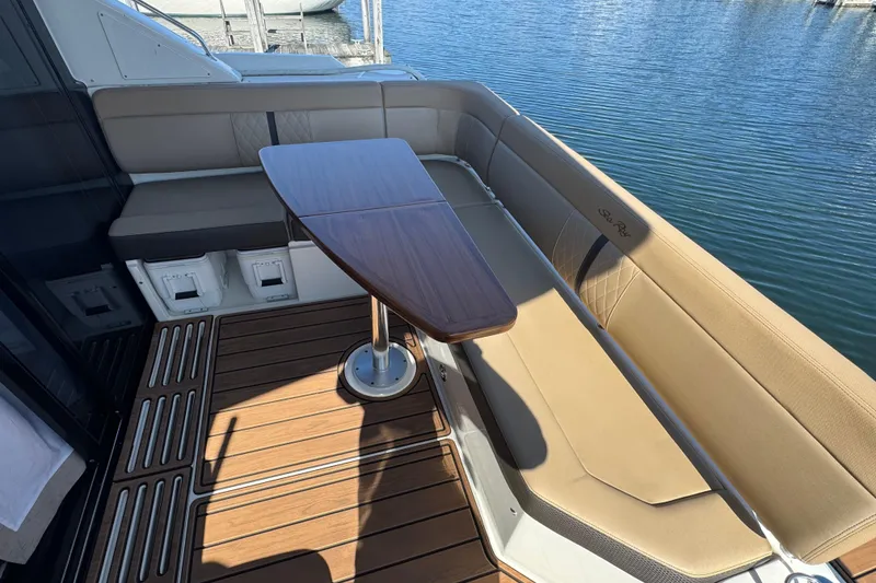 Slide: The Image of Luxurious seating area on 2017 Sea Ray Sundancer 400 yacht with wooden table. - 12