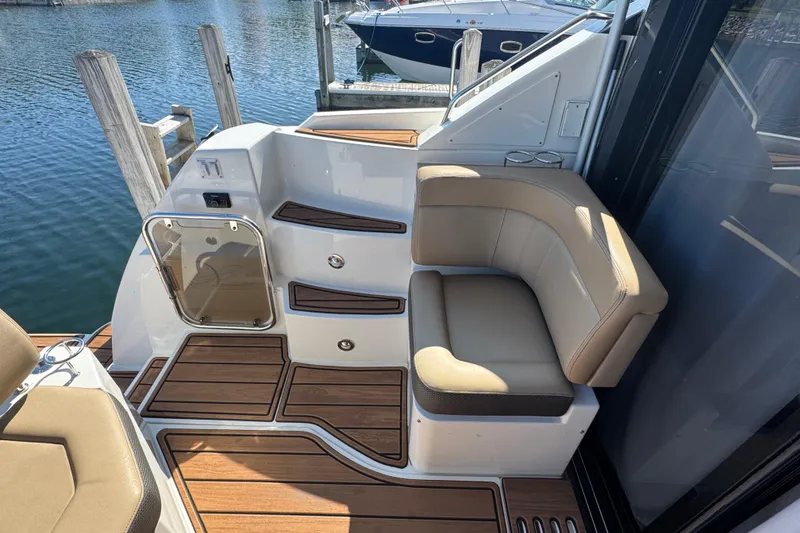 Slide: The Image of 2017 Sea Ray Sundancer 400 boat deck with seating, wood flooring, and water view. - 13