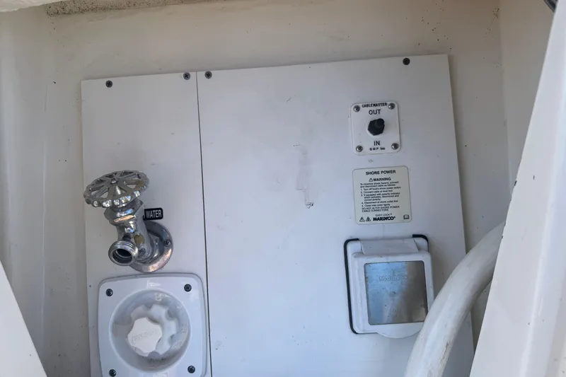 Slide: The Image of 2017 Sea Ray Sundancer 400 boat utility panel with water and power connections. - 14