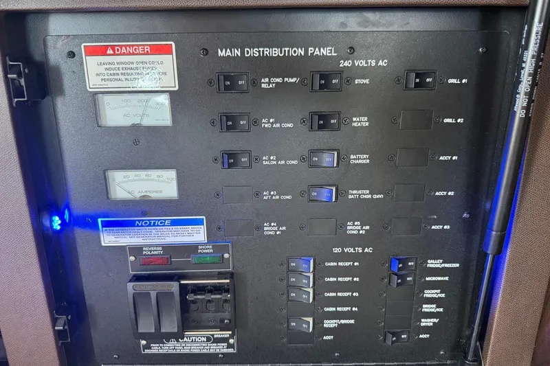 Slide: The Image of Main distribution panel of 2017 Sea Ray Sundancer 400 boat with switches and meters. - 17
