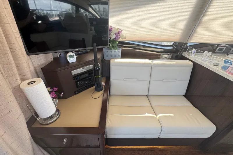 Slide: The Image of Interior of 2017 Sea Ray Sundancer 400 yacht with TV, seating, and decor. - 18