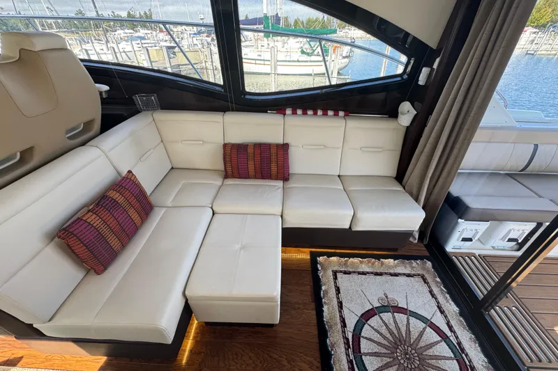Slide: The Image of Luxurious interior of 2017 Sea Ray Sundancer 400 yacht with white leather seating and decorative pillows. - 19