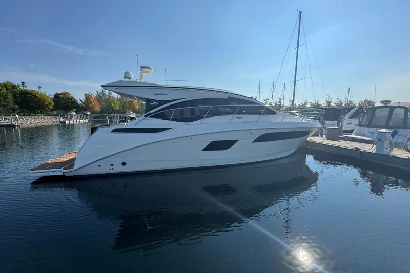 Slide: The Image of 2017 Sea Ray Sundancer 400 yacht docked in a serene marina setting. - 2
