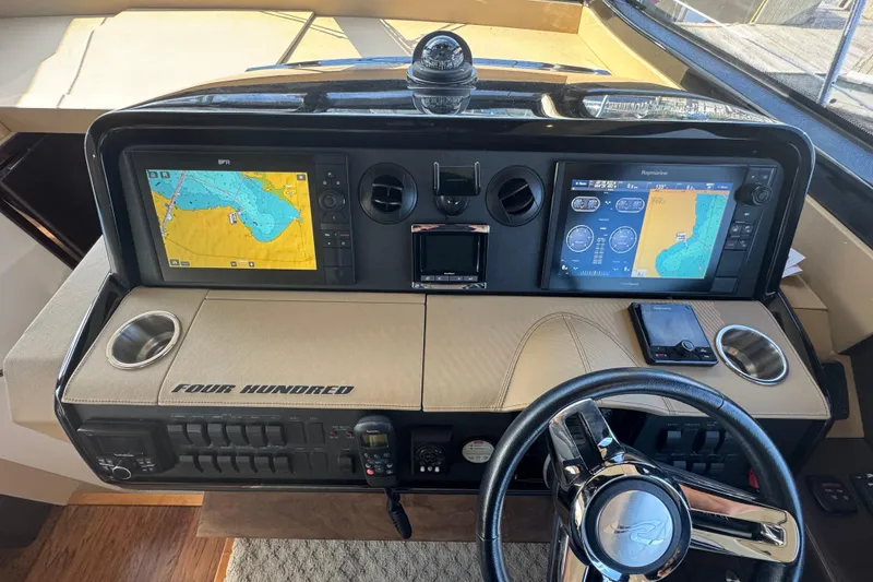 Slide: The Image of 2017 Sea Ray Sundancer 400 helm with dual navigation screens and steering wheel. - 24