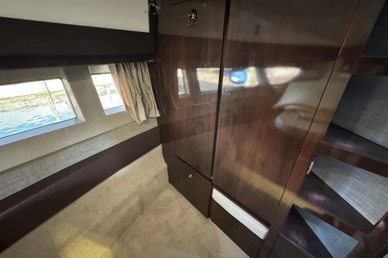 Slide: The Image of Interior of 2017 Sea Ray Sundancer 400 yacht with wood paneling and windows. - 30
