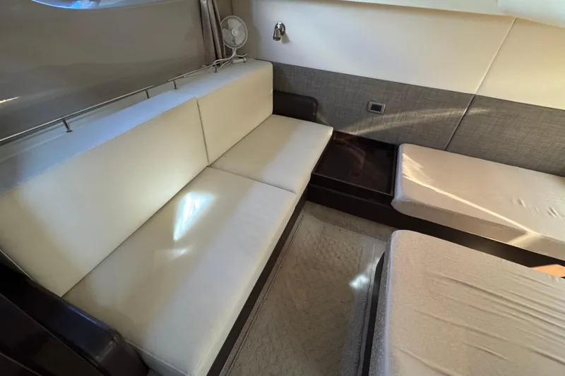 Slide: The Image of Interior of 2017 Sea Ray Sundancer 400 yacht with white seating and twin beds. - 33