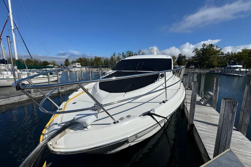 Slide: The Image of 2017 Sea Ray Sundancer 400 yacht docked at a marina under clear blue skies. - 4