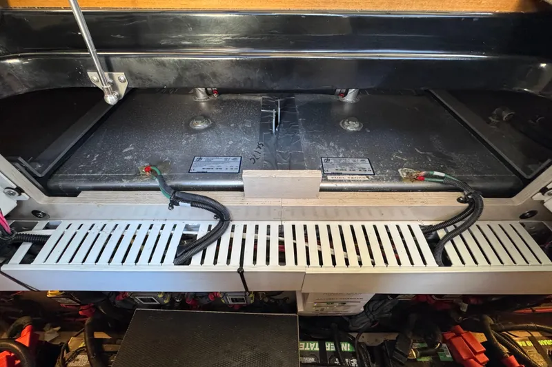 Slide: The Image of Engine compartment of a 2017 Sea Ray Sundancer 400, showcasing battery and wiring setup. - 41
