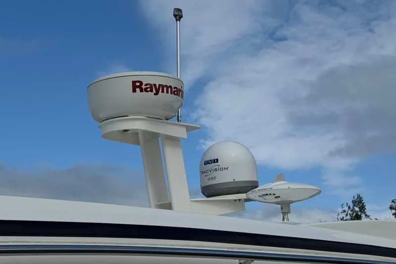 Slide: The Image of Radar and satellite equipment on 2017 Sea Ray Sundancer 400 against a cloudy sky. - 45