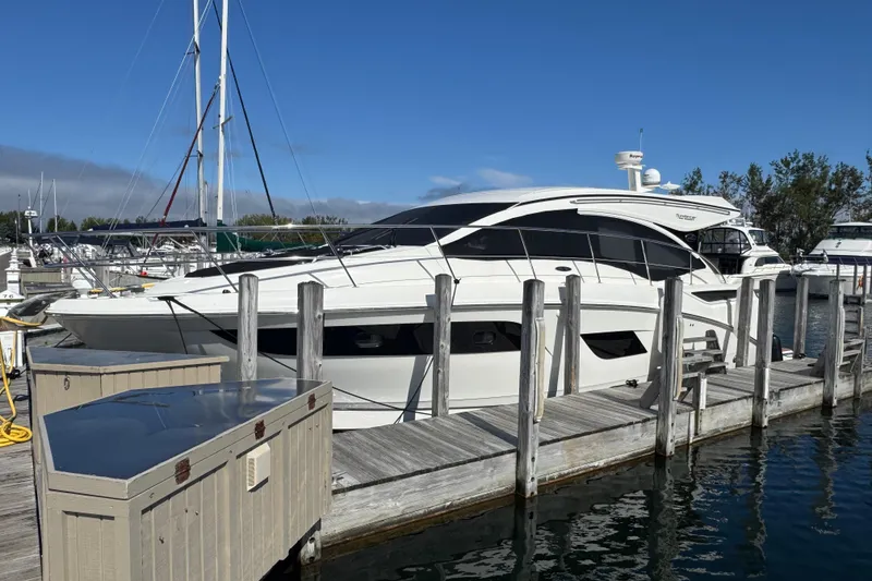 Slide: The Image of 2017 Sea Ray Sundancer 400 yacht docked at marina under clear blue sky. - 5