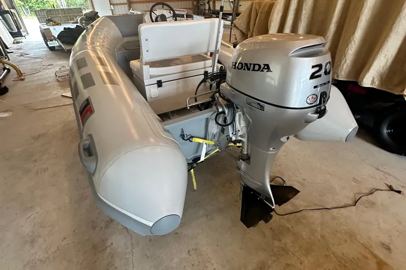 Slide: The Image of Inflatable boat with Honda 20 outboard motor in a garage setting. - 51