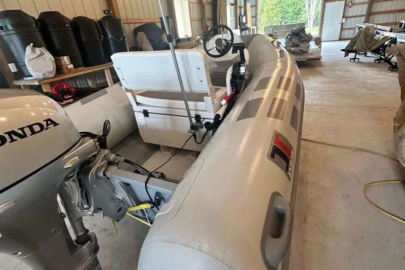 Slide: The Image of Inflatable boat with Honda motor in a storage area, associated with 2017 Sea Ray Sundancer 400. - 53