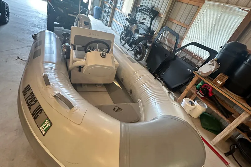 Slide: The Image of Inflatable boat in garage with Sea Ray Sundancer 400, 2017 model, in background. - 54