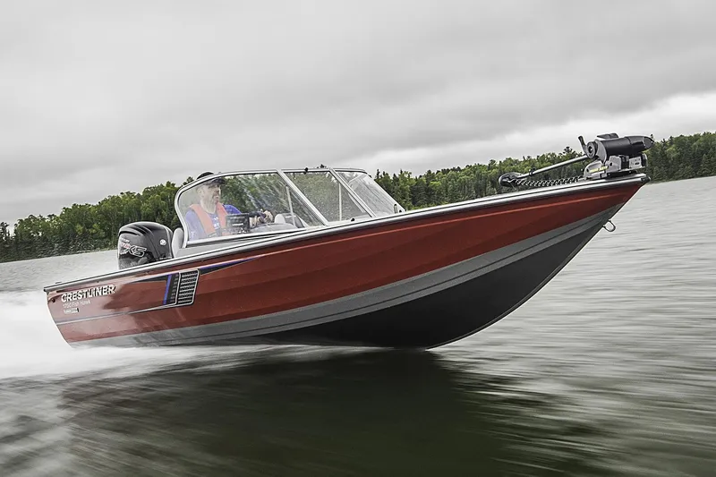 Slide: The Image of 2018 Crestliner 1750 Fish Hawk SC boat on trailer, parked outdoors under a clear sky. - 1