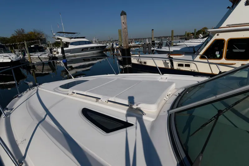 Slide: The Image of 2012 Sea Ray 330 Sundancer docked at marina, surrounded by other boats. - 15