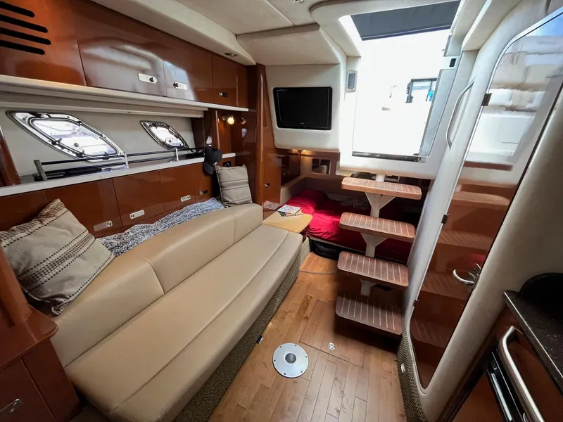 Slide: The Image of Interior of 2012 Sea Ray 330 Sundancer yacht with cozy seating and modern amenities. - 21