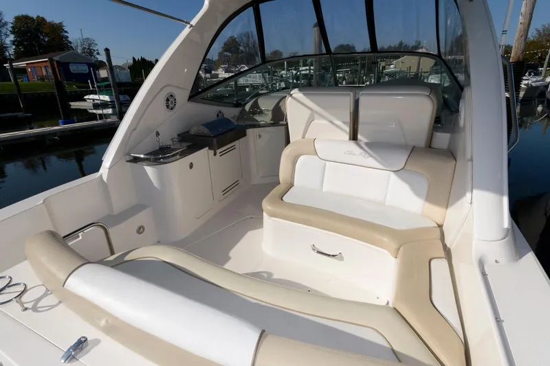 Slide: The Image of 2012 Sea Ray 330 Sundancer boat interior with seating and kitchenette. - 6